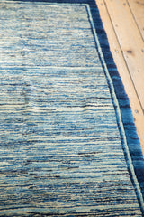 Unusual striated indigo running water pattern and deep blue border of the antique Peking rug.