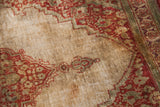 Storied patina and fine weave on the ivory silk field of an antique Haji Jalili Tabriz rug.
