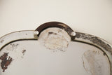 Close-up of vintage deco mirror showing distressed silvered glass and curved frame.