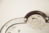 Curvy beveled glass edge with a faceted rhinestone on the distressed mirror.