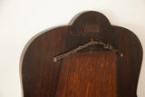 Back of vintage 1930s bell-shaped mirror, showing dark weathered wood and hanging wire.