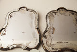 Vintage Art Deco mirror detail with weathered silvering and dark, distressed curved frame.