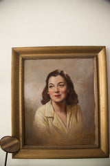1950s oil portrait close-up: woman's hopeful face, pearl earrings, yellow blouse.
