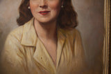 Close-up of the woman's yellow shirt, visible mark, and ornate gold frame detail.