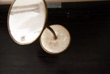 Mid Century mirror base, round white lucite shell with slight separation, brass rim.
