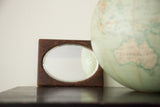 Vintage 1940s dark wood mirror, rectangular frame, oval beveled glass, aged patina, 5x7 inches.