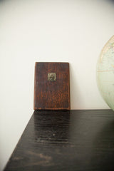 Back of the 1940s wood mirror, showing aged mahogany patina and decorative metal accent.