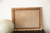 Aged wooden stretcher bars and discolored canvas backing of the 18th century French engraving.