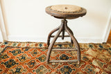 Victorian antique industrial wooden stool with worn seat, exposed horsehair, and aged wood legs.