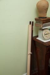 Vintage anatomy chart rolled for storage, showing its original wooden dowels.