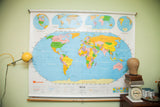 Vintage 1990s Nystrom World USA pulldown map with colorful continents, blue oceans.