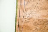 Close-up of the 1860 antique New York map, showing aged linen texture, text detail, and green edge.