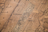 Aged, sepia-toned detail of Central Park, Harlem, and street grid on 1860 New York City map.