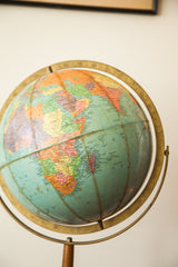 Mid-century Repologie globe detail showing blue ocean, Southern Africa, and brass meridian.