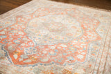 Fine weave showcasing delicate peach, ivory, and light blue floral motifs on an antique silk Tabriz mat.