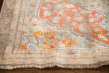 Secured fringe and light coral, blue, ivory floral border on antique Tabriz silk rug.