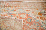 Secured fringe and delicate floral motifs of the antique silk Tabriz rug in light terracotta.
