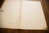 Aged reverse side of the antique map, revealing creases, water stains, and handwritten text.