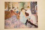The artist's signature is visible on this vintage Toulouse Lautrec print of a salon scene.