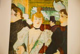 Detailed view of the central woman and patrons in a vintage Toulouse Lautrec print.