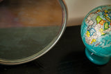 Silver circular edge of the vintage Deco shaving mirror with warm reflections.