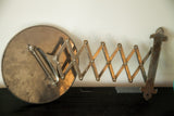 Extended metal accordion arm with original fleur de lis wall mounting hardware.