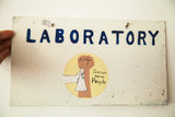 Distressed top left of the vintage aluminum sign with blue 