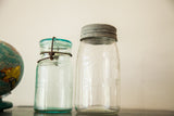 Antique clear Beaver mason jar and blue Lightning mason jar, both with original lids.