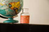 Antique Poison Morphine bottle, clear glass with intact orange-red label, skull and crossbones.