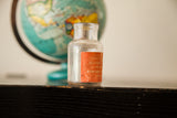 Clear antique poison bottle showing its worn orange 'Sulphate of Morphine' label.