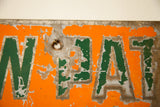 Chipped orange and green paint on antique Cow Path metal sign, with 