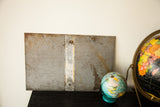 Aged reverse side of the vintage metal Cow Path sign, showing rust and texture.