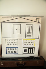 Vintage Massachusetts Vision Test eye chart showing Snellen's Test Symbols with yellow and blue E blocks.