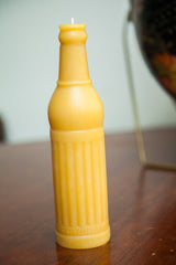 Beeswax soda pop bottle candle with detailed crosshatch, vertical ridges, and bottom text.