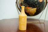 Embossed owl and 'Owl Drug & Co.' text on the vintage bottle beeswax candle.
