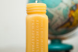 Antique Bottle Beeswax Candle, golden yellow with embossed apothecary text and threaded top.