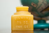 Antique Bottle Beeswax Candle molded as a yellow 19th-century Diamond Ink Co. jar.