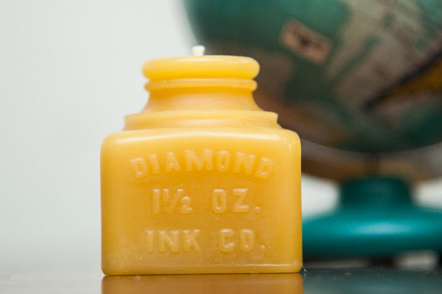 Antique Bottle Beeswax Candle molded as a yellow 19th-century Diamond Ink Co. jar.