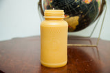 XXL beeswax candle, antique Old Judge Coffee bottle with owl and harlequin pattern.