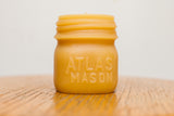 Natural beeswax candle shaped like an antique Atlas Mason jar, 3 3/8 inches tall.