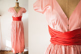 Rare 1950s Claire McCardell pale pink wrap dress, bold red sash, brass hook detail.