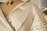 Close-up of the ruched sleeve and wide collar on the 1950s ivory silk satin gown.