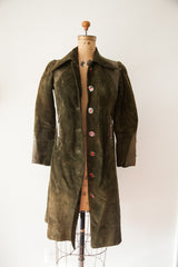 Vintage Gucci suede coat's silhouette, showing the open front and enamel button details.