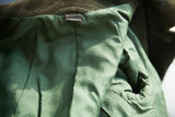 Close-up of the forest green silk lining with its repeating Gucci insignia.
