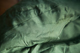 Repeating Gucci insignia pattern on the forest green silk lining inside the vintage coat.