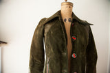 Detail of the pointed collar and striped enamel button on the vintage Gucci suede coat.
