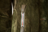 Close-up of the red and navy enamel stripe accent on the forest green suede Gucci coat.