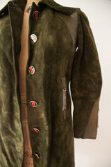 Side view of the Gucci suede coat showing its striped enamel buttons and leather pocket detail.