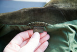 Vintage Gucci leather label with gold script on the coat's green silk insignia lining.