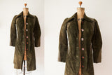 Vintage 1970s Gucci suede coat in forest green with leather details and enamel buttons.